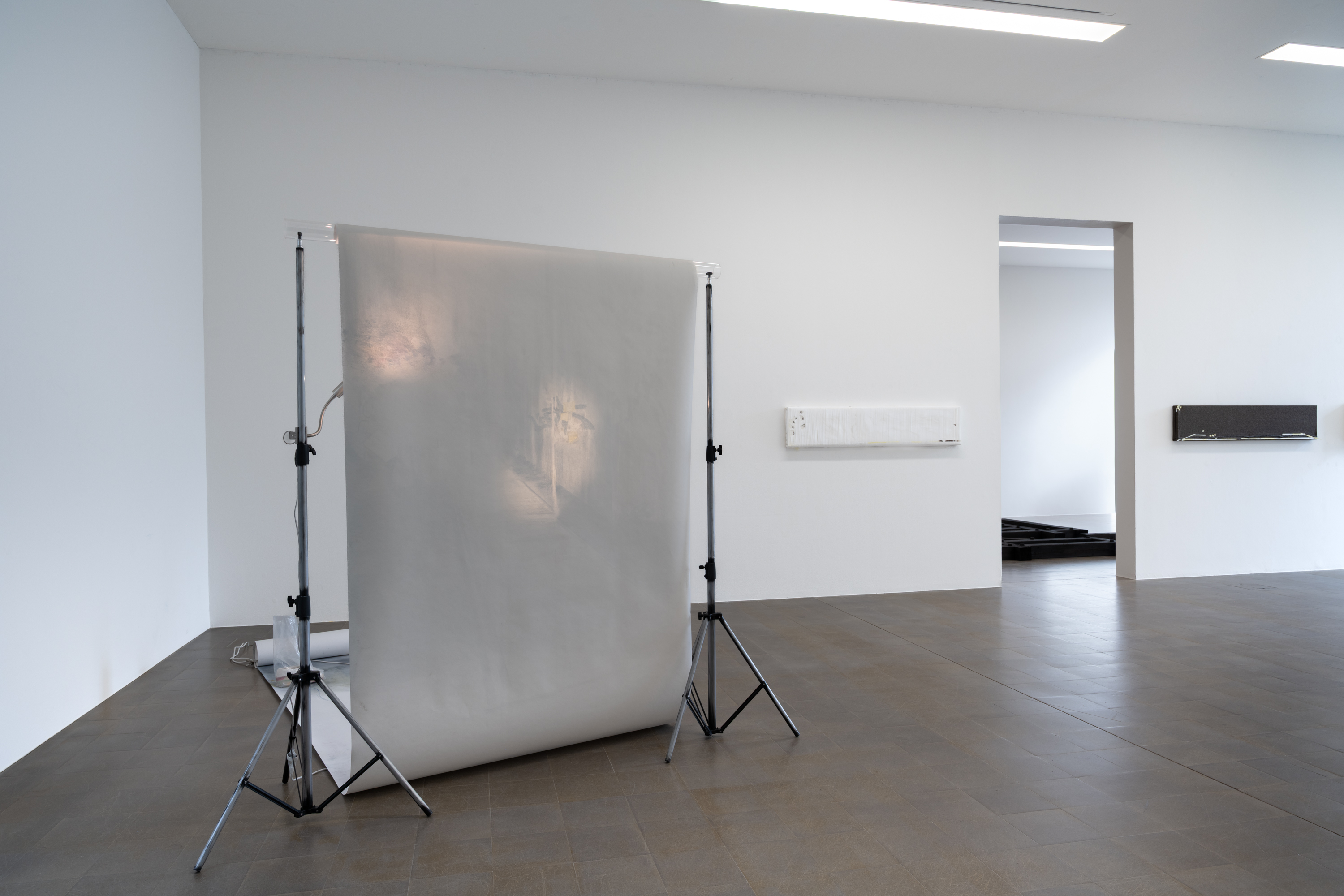 Estéfana Román Matesanz, *A Flick to Stop the Ball in Mid-Flight*, 2025/26. Tripod, umbrella, clothing, wax
and fabric, pastels, charcoal and pencil, spray paint on paper, Dimensions variable. Photo: Finn Curry.